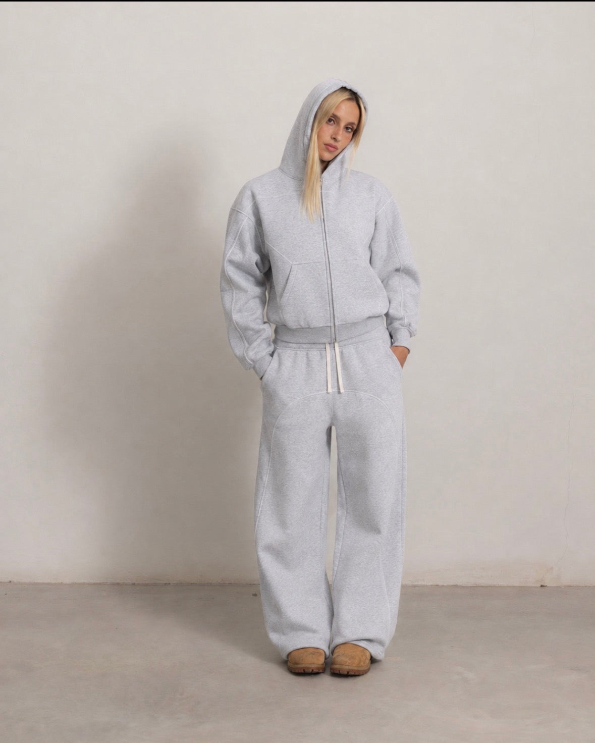 Grey outer-stitched hoodie and sweatpants, front view